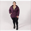 Woman in a hooded purple puffer jacket wearing Snow Country Outerwear’s packable down coat
