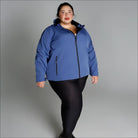 Woman in blue hooded jacket and black leggings wearing plus size Micro Fleece Soft Shell outerwear
