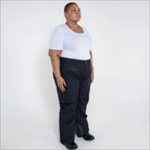 Woman in black ski pants and white t-shirt wearing Women’s Plus Size Winter Ski Pants
