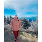 Woman in pink puffer jacket wearing hooded coat from Women’s Plus Size Packable Down Outerwear