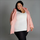 Woman in pink puffer jacket showcasing Women’s 1X-6X Plus Packable Down Coat Outerwear