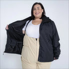Woman in black jacket and beige overalls wearing Snow Country Plus Size Ski Jacket
