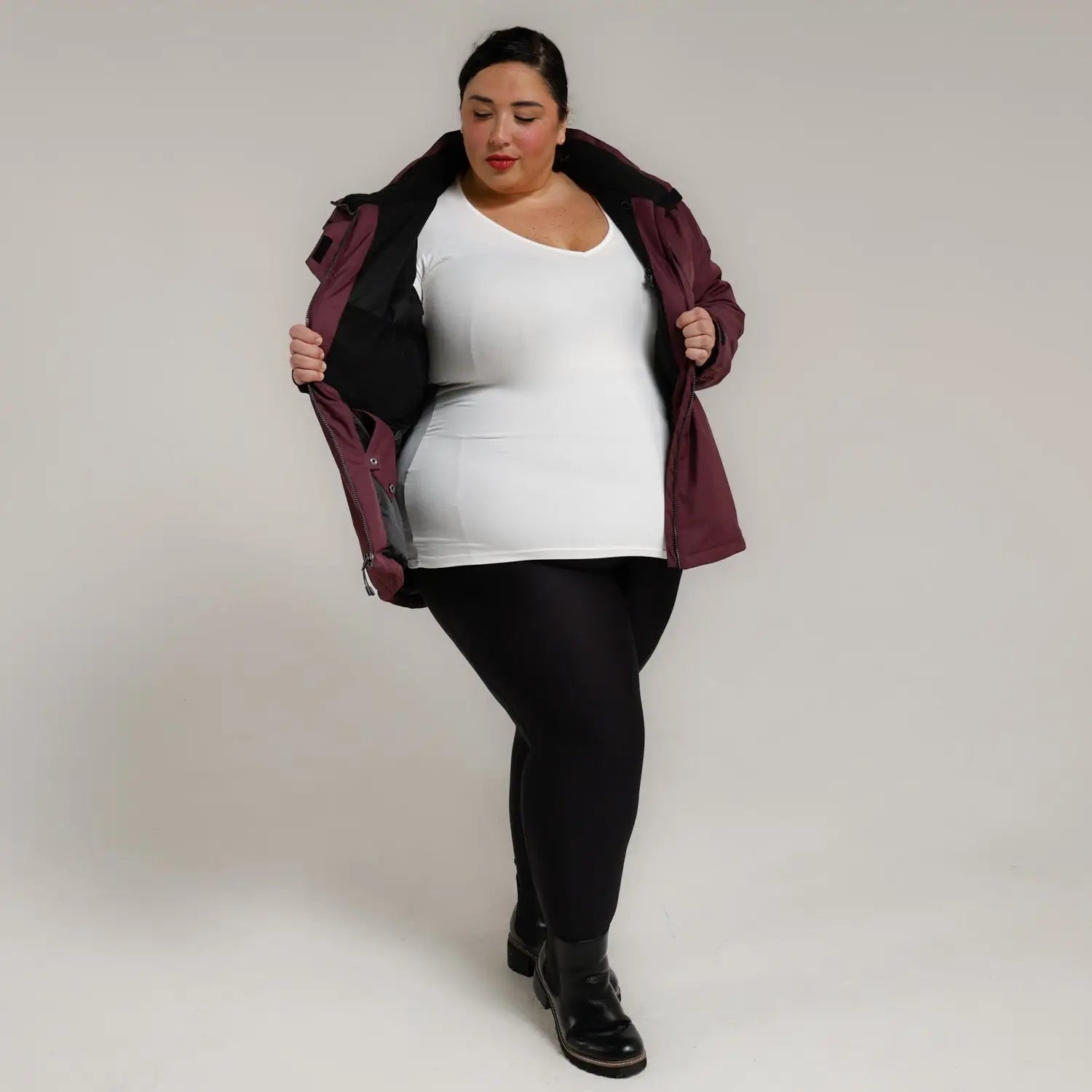 Burgundy jacket with black leggings and boots from Snow Country Outerwear Plus Size Ski Coat