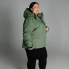 Woman wearing a green hooded winter coat from Snow Country Outerwear Plus Size collection