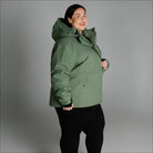 Woman wearing a green hooded winter coat from Snow Country Outerwear Plus Size collection