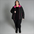 Woman wearing black and pink winter down alternative 3-in-1 coat jacket snow country outerwear