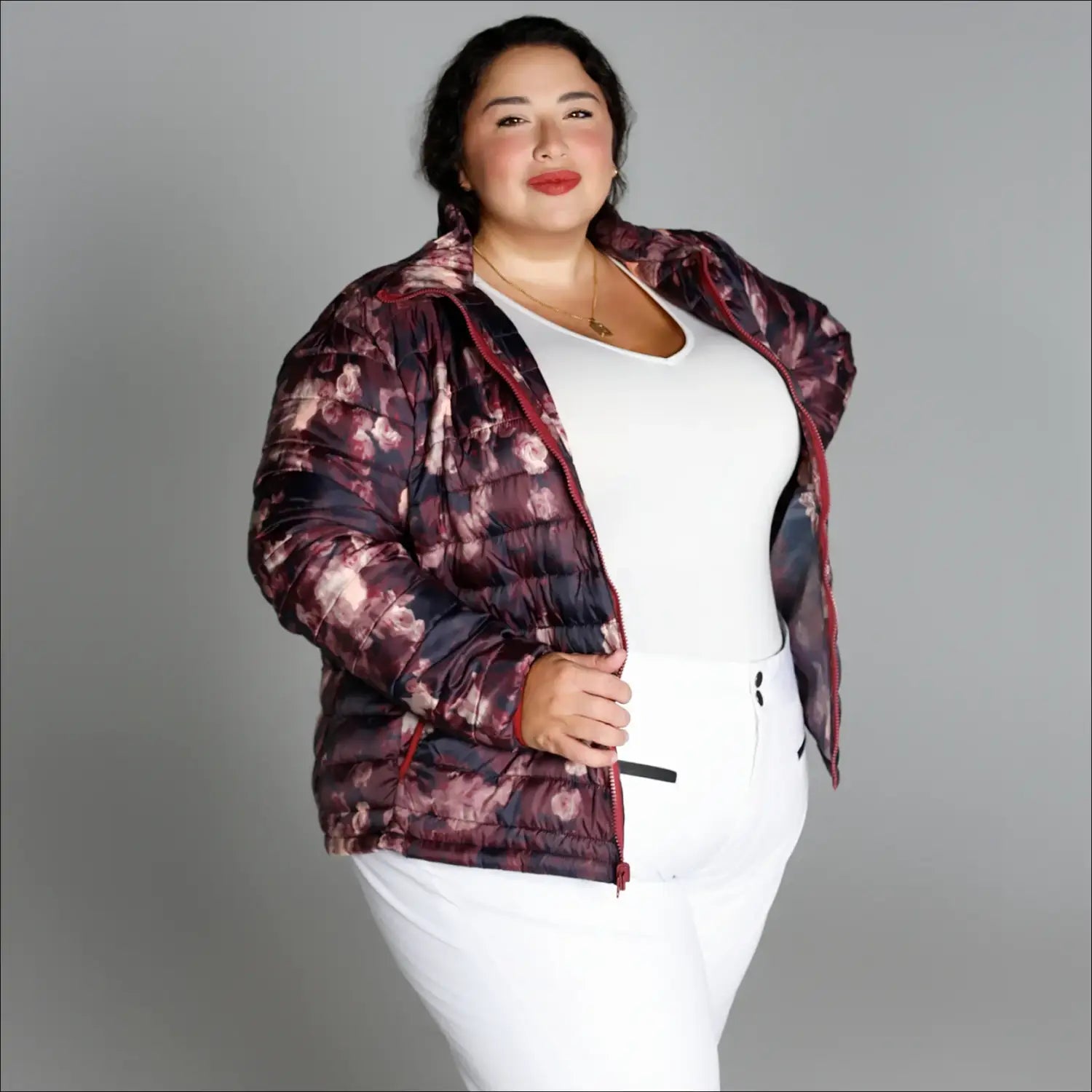 Woman wearing floral puffer jacket from Women’s Plus Size 1X-6X Winter Down Alternative Coat