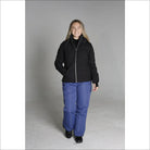 Woman wearing black jacket and blue snow pants in Snow Country Outerwear Vail Ski Jacket