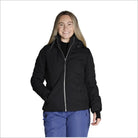 Woman wearing black puffer jacket and blue pants in Snow Country Outerwear Vail ski coat
