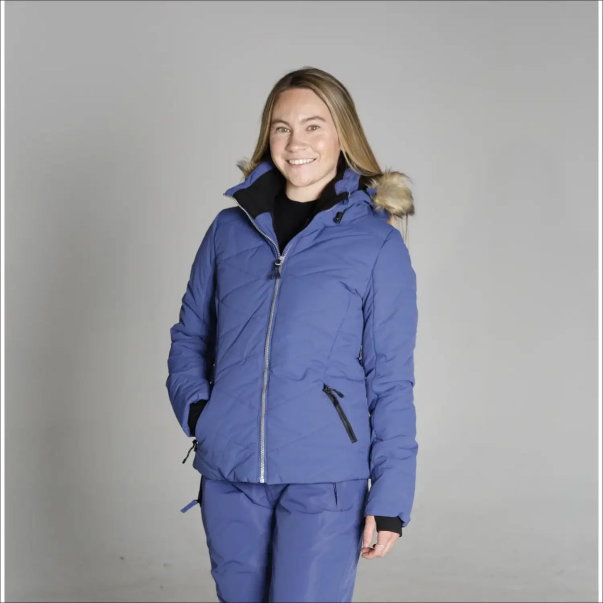 Blue down ski jacket with fur hood from Snow Country Outerwear Vail collection