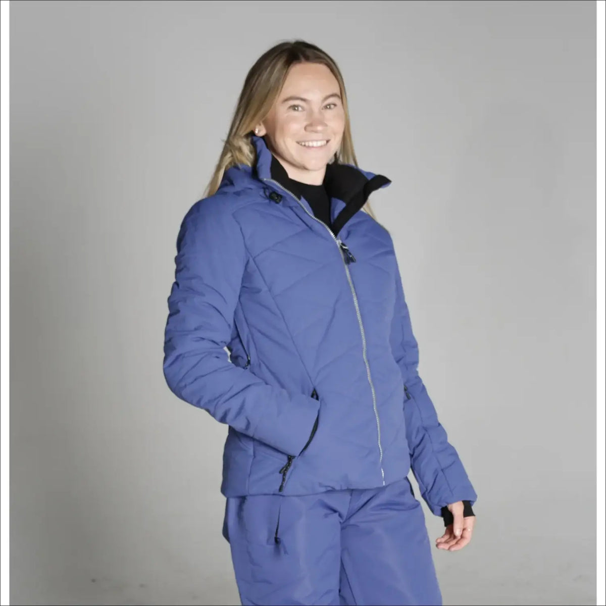 Woman in blue Ski Suit wearing Snow Country Womens Vail Down Alternative Ski Jacket