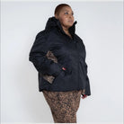 Plus size women’s winter snow ski jacket featuring a black puffer design with leopard print accents
