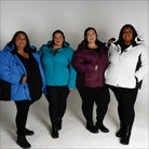 Four plus-size women wearing colorful Snow Country Outerwear Aspen Ski Jackets