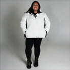 Woman in white puffer jacket from Snow Country Outerwear Women’s Aspen Ski Coat