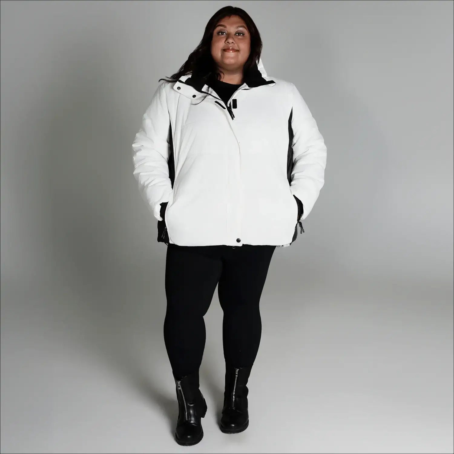 Woman in white puffer jacket from Snow Country Outerwear Women’s Aspen Ski Coat