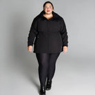 Plus size women wearing black jacket and leggings outfit featuring Stowe Mid Length Soft Shell Jacket
