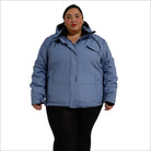 Woman wearing a blue plus size insulated snow board ski coat in winter outdoor setting