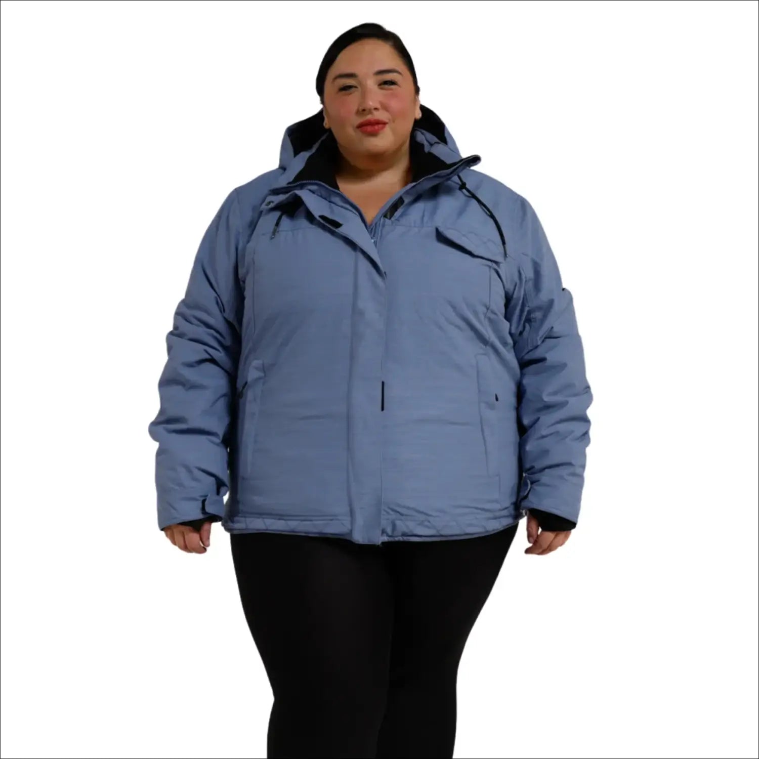 Woman wearing a blue plus size insulated snow board ski coat in winter outdoor setting