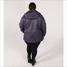 Woman wearing a dark blue hooded ski jacket and black leggings for Pulse Plus Size 3-in-1 Coat