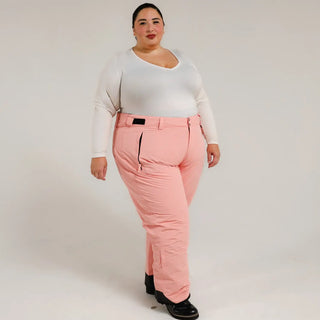 Woman wearing pink Snow Country insulated ski pants in a winter outdoor setting