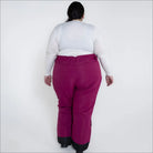 Woman wearing magenta Snow Country insulated ski pants for women in plus sizes