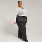 Woman wearing a white top and black pants showcasing Snow Country Plus Size Insulated Ski Pants