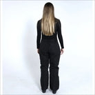 Woman wearing black ski pants and a long-sleeved shirt for Snow Country Outerwear Ski Pants