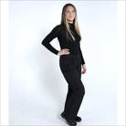 Woman in black turtleneck and pants wearing Snow Country Women’s Ski Pants for snowboarding