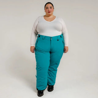 Woman wearing teal Snow Country insulated ski pants for plus size winter outdoor activity