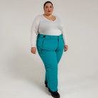Woman wearing teal insulated ski pants from Snow Country Outerwear for women
