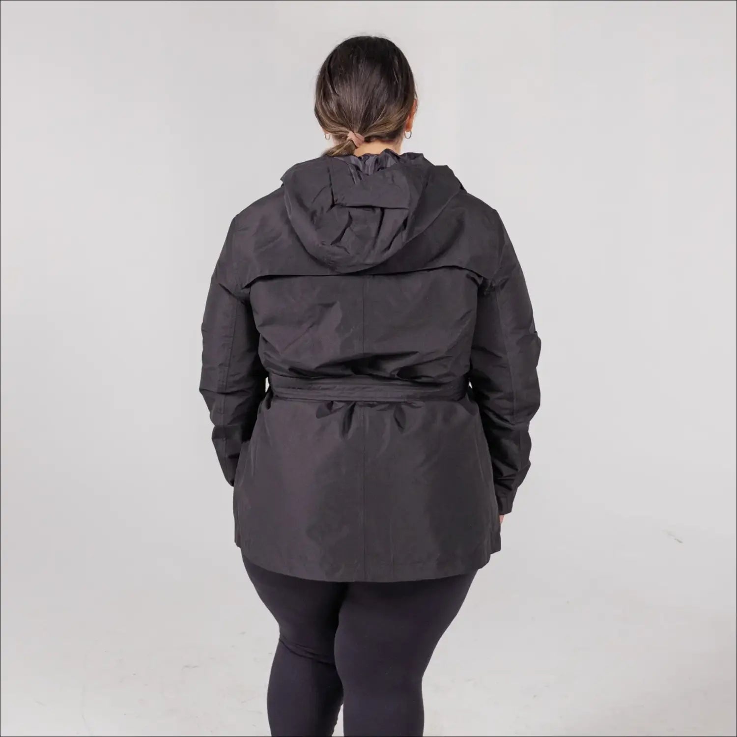 Black belted hooded jacket from Snow Country Outerwear Women’s Rain Jacket collection