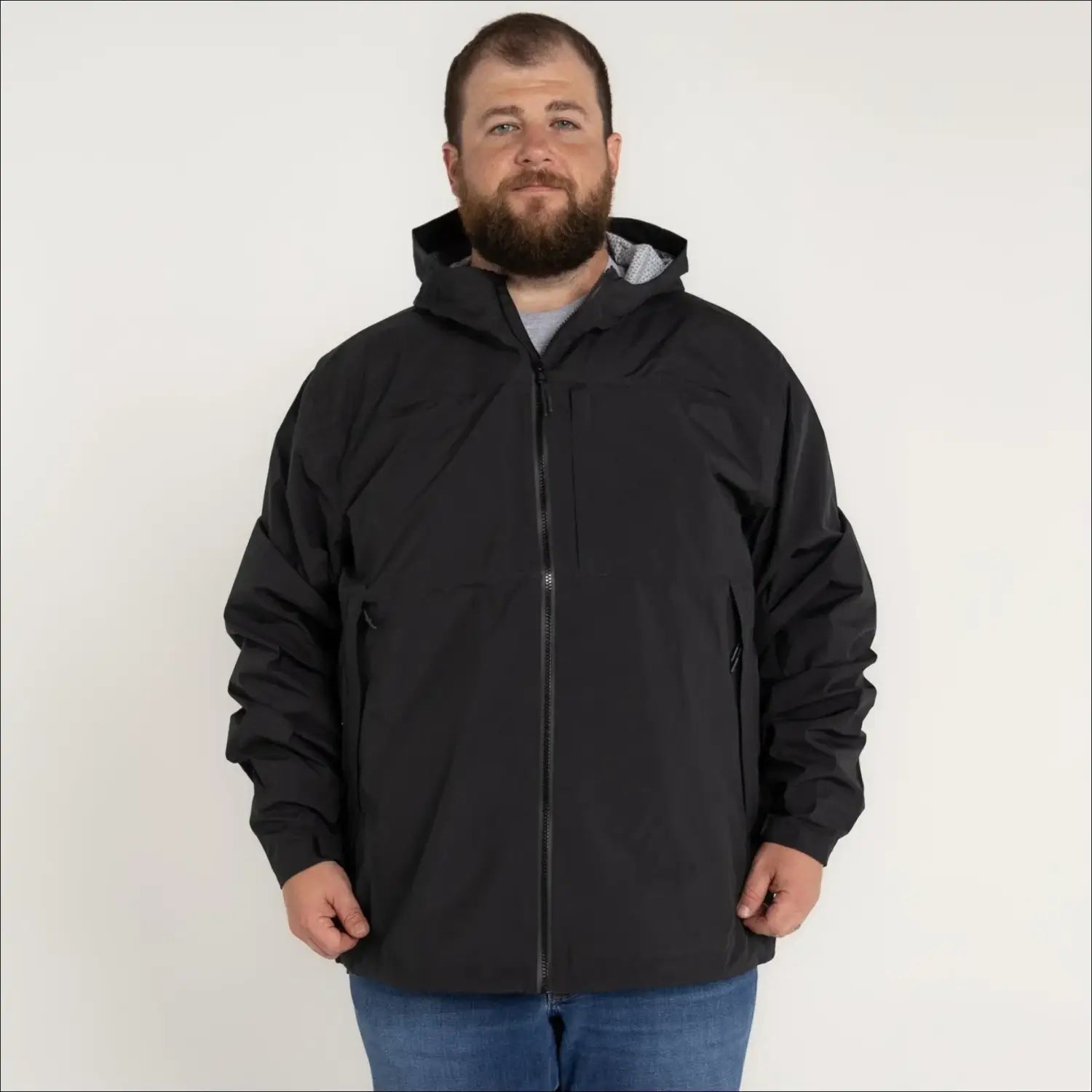 Man in black hooded jacket wearing Rugged Rainier Windbreaker Coat Snow Country Outerwear