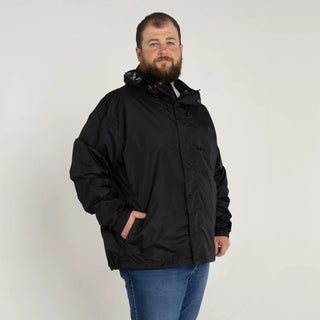 Man wearing black Snow Country Outerwear packable hooded rain jacket in big sizes
