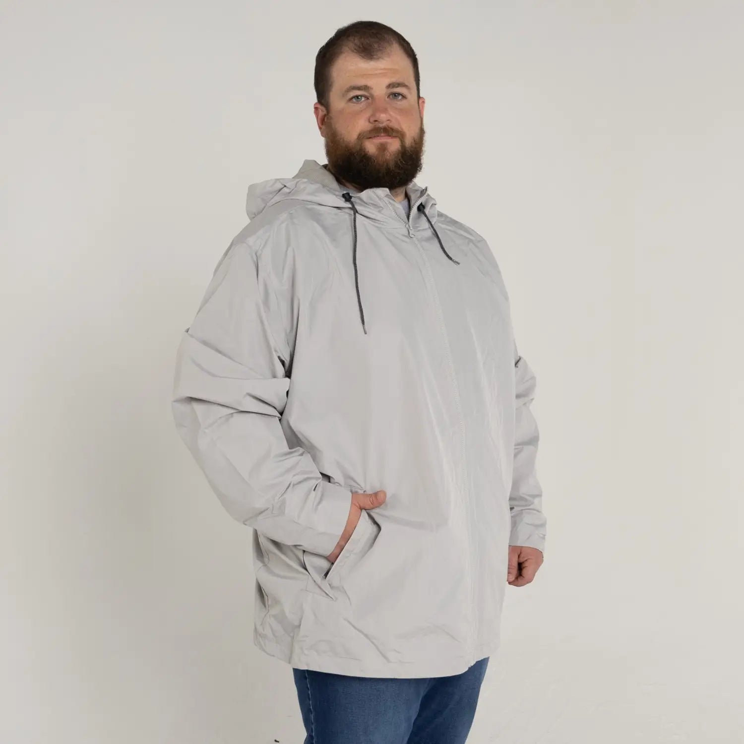 Man wearing a gray hooded anorak from Men’s Big 3XL-7XL Rain Jacket Windguard Coat