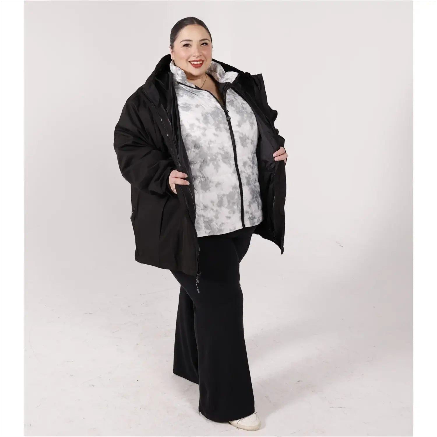 Plus size woman wearing black winter down alternative 3-in-1 coat in snowy outdoor setting