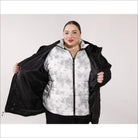 Woman wearing a black and white plus size winter 3-in-1 down alternative coat