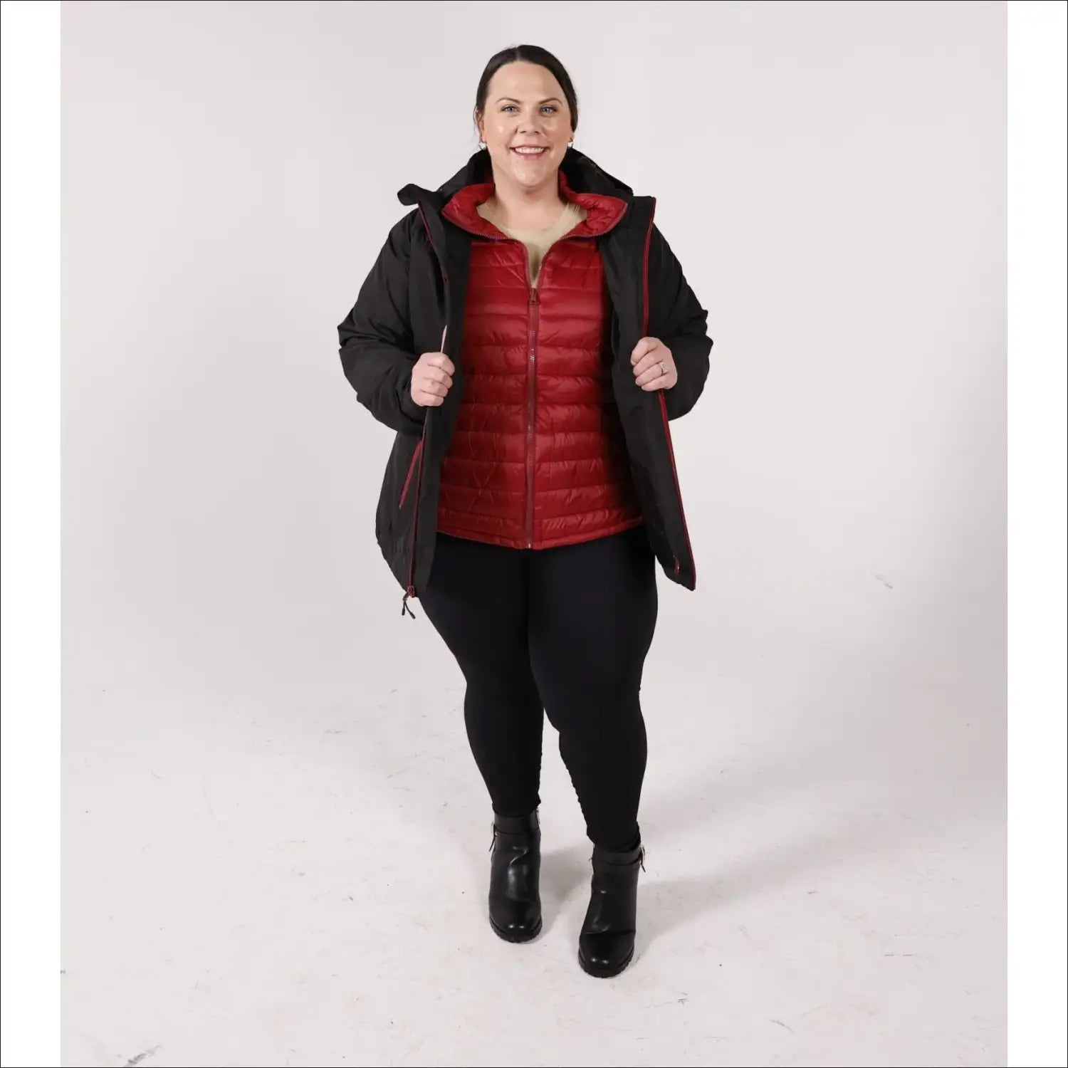 Woman in black coat and red vest wearing winter down alternative 3-in-1 jacket