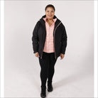 Plus size winter coat for women featuring black outer layer and pink vest with snow-ready style