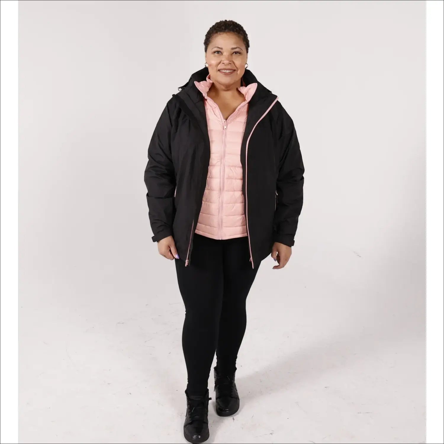 Plus size winter coat for women featuring black outer layer and pink vest with snow-ready style