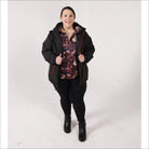 Woman wearing a black hooded winter down alternative 3-in-1 coat jacket outdoors