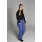Woman wearing blue Snow Country ski pants and black turtleneck for snowboarding