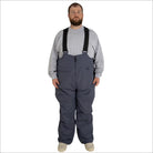 Man wearing gray bib overalls from Snow Country Outerwear men’s insulated ski snow bibs