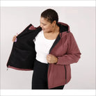 Woman wearing a hooded mauve-colored micro fleece soft shell jacket for spring or fall outerwear