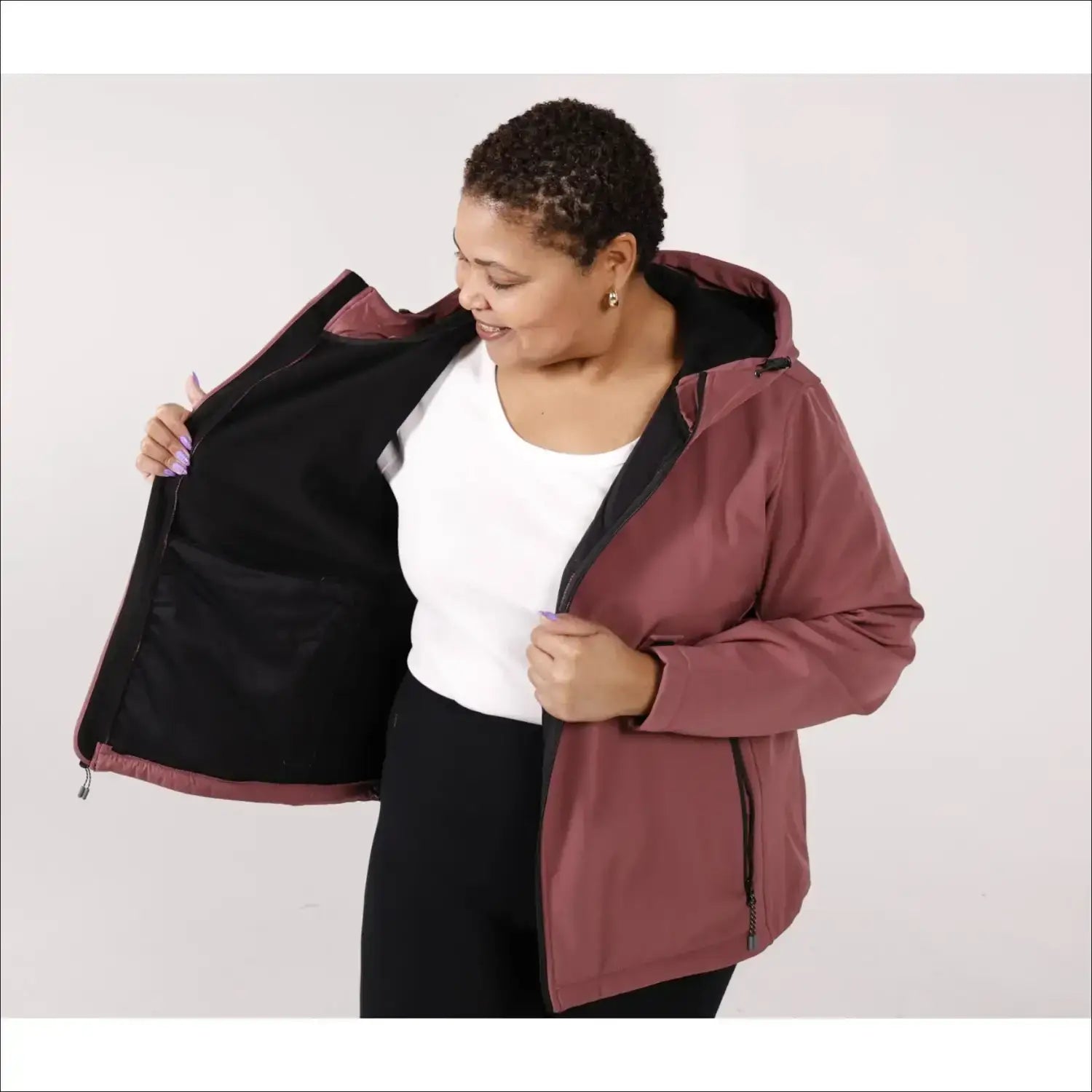 Woman wearing a hooded mauve-colored micro fleece soft shell jacket for spring or fall outerwear