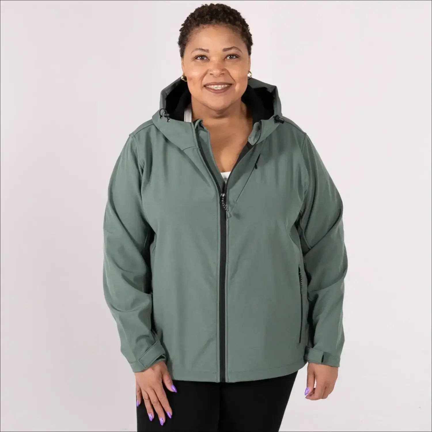 Woman wearing a hooded green plus size fleece soft shell jacket for spring or fall outerwear