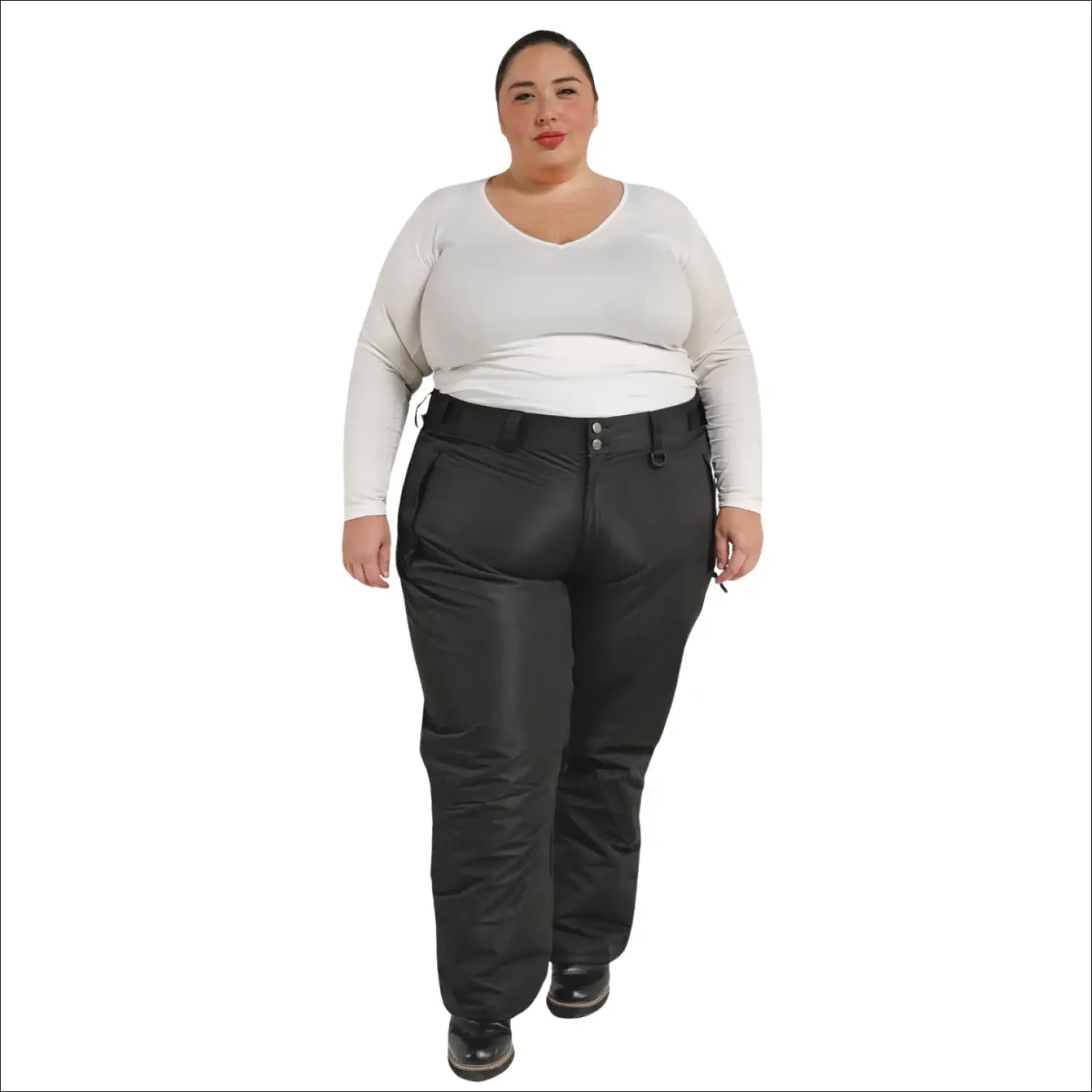 Woman wearing black Snow Country insulated plus size ski pants in a snowy mountain setting