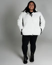 Woman in white puffer jacket from Snow Country Outerwear Women’s Aspen Ski Coat