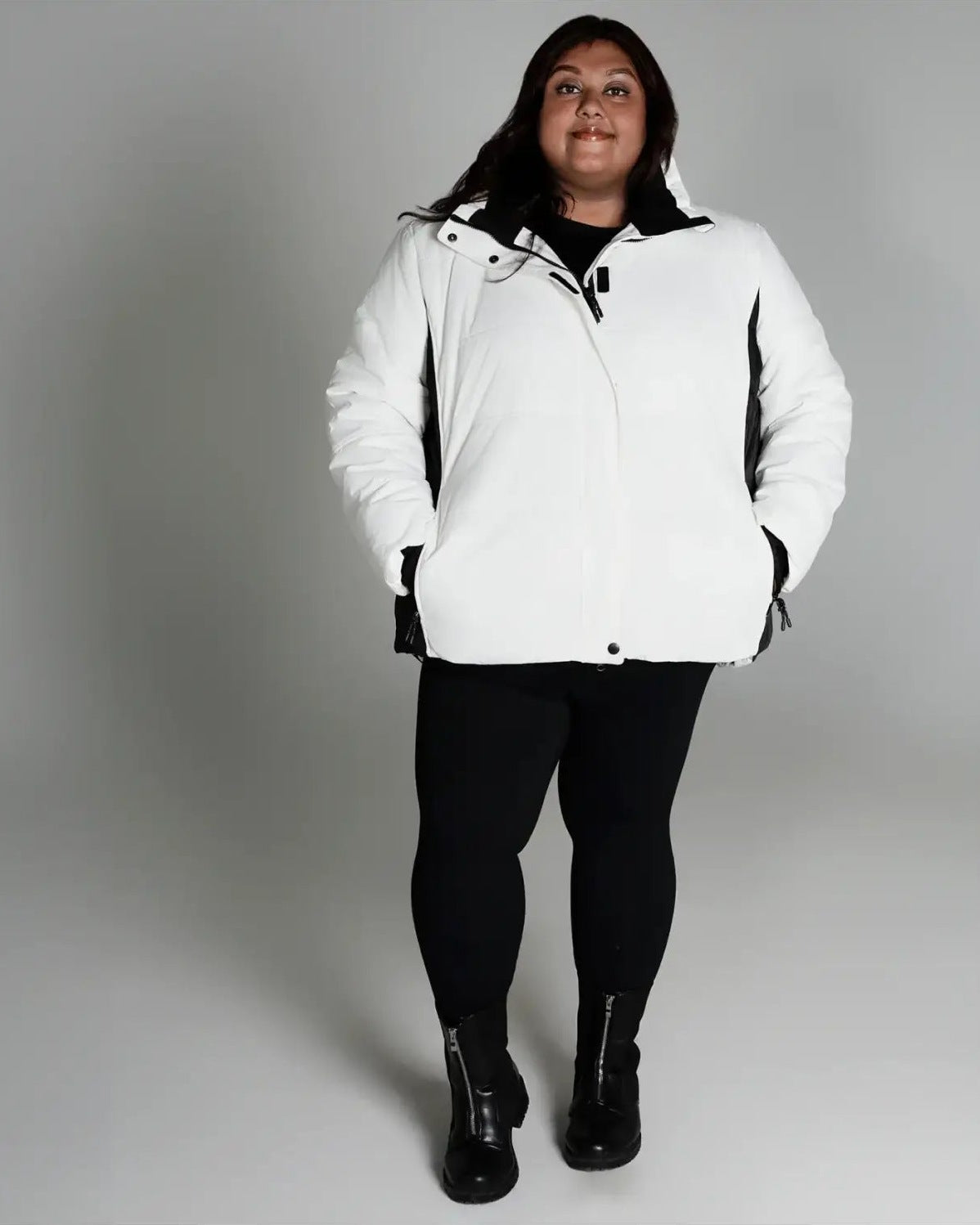 Woman in white puffer jacket from Snow Country Outerwear Women’s Aspen Ski Coat