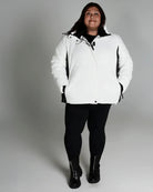 Woman in white puffer jacket from Snow Country Outerwear Women’s Aspen Ski Coat
