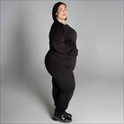 Woman in black outfit wearing Snow Country Outerwear Women’s Plus Size 1X-6X base layer